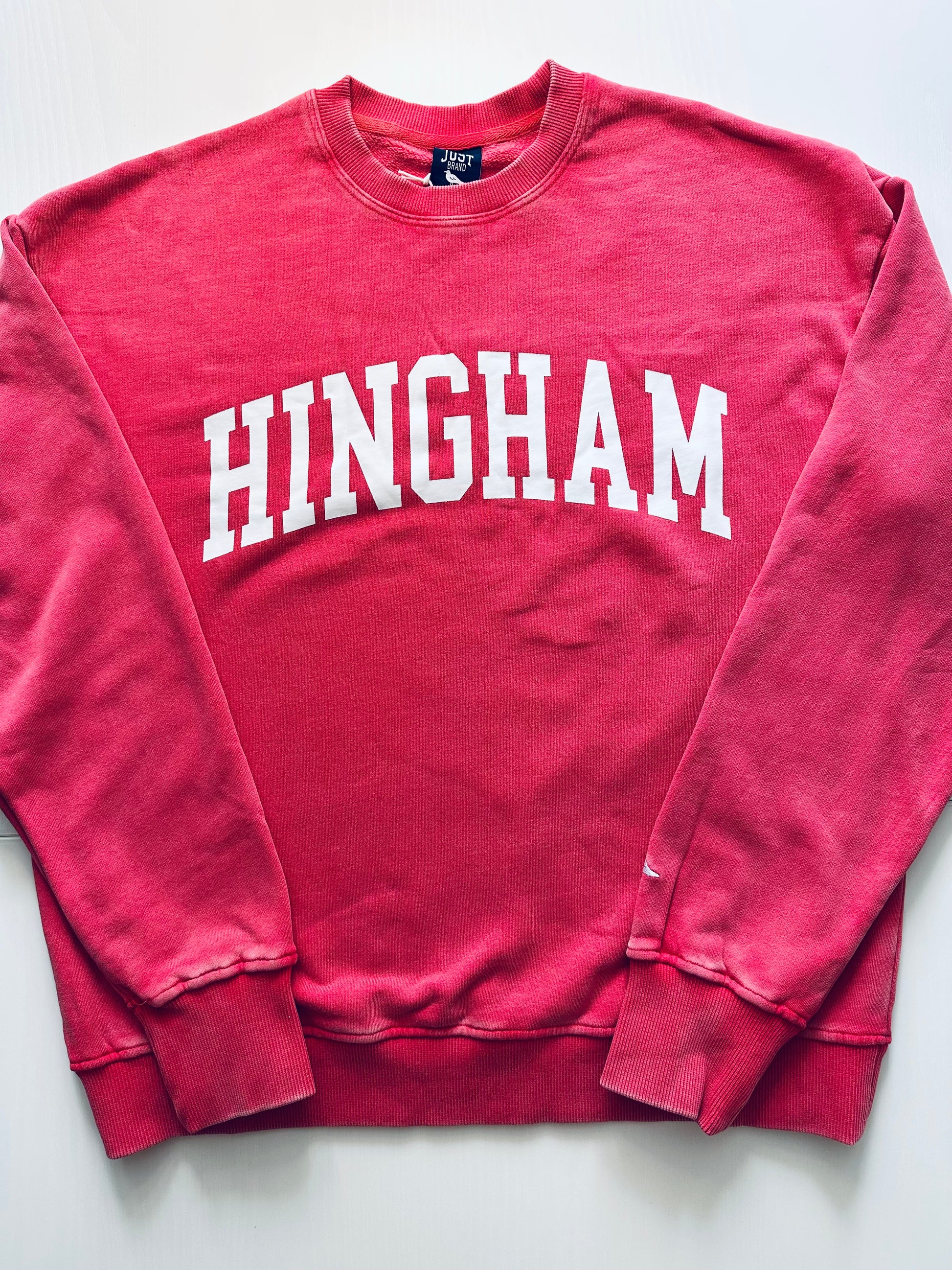 Red sweatshirt with 'HINGHAM' printed on it against a white background