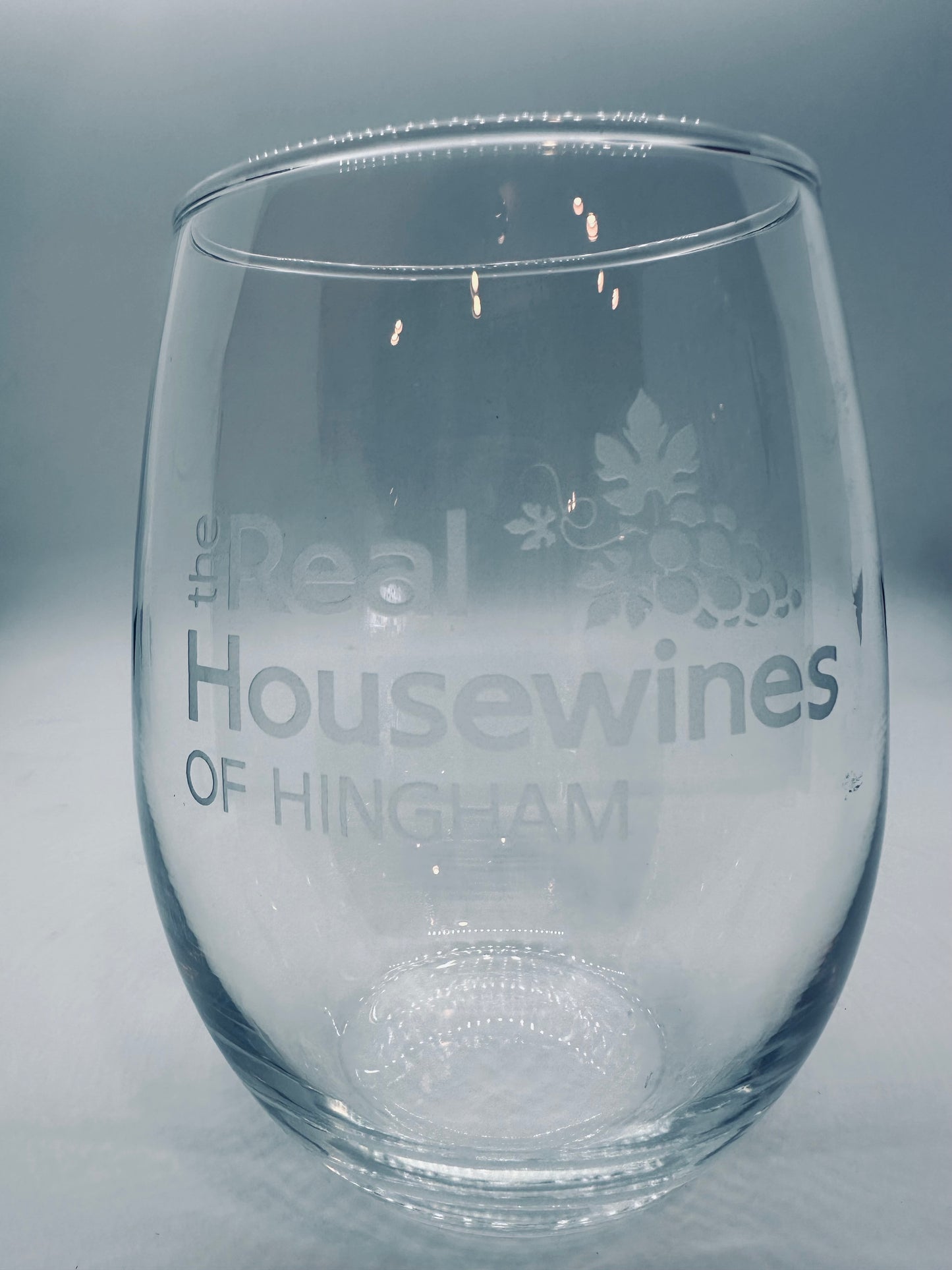 Clear stemless wine glass with 'Real Housewines of Hingham' text and logo