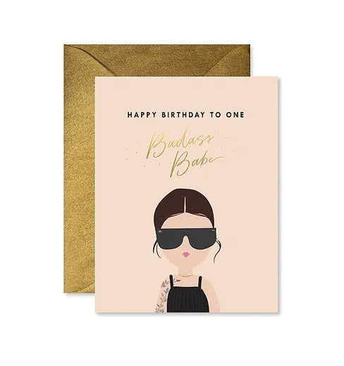 Light Pink card with writing ' Happy Birthday to one badass babe' . An image of a gift in sunglasses with tattoos on arm