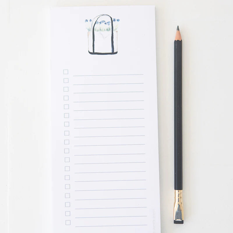 Tear away list style notepad with an image of a tote with flowers  Notepad is lined with check boxes