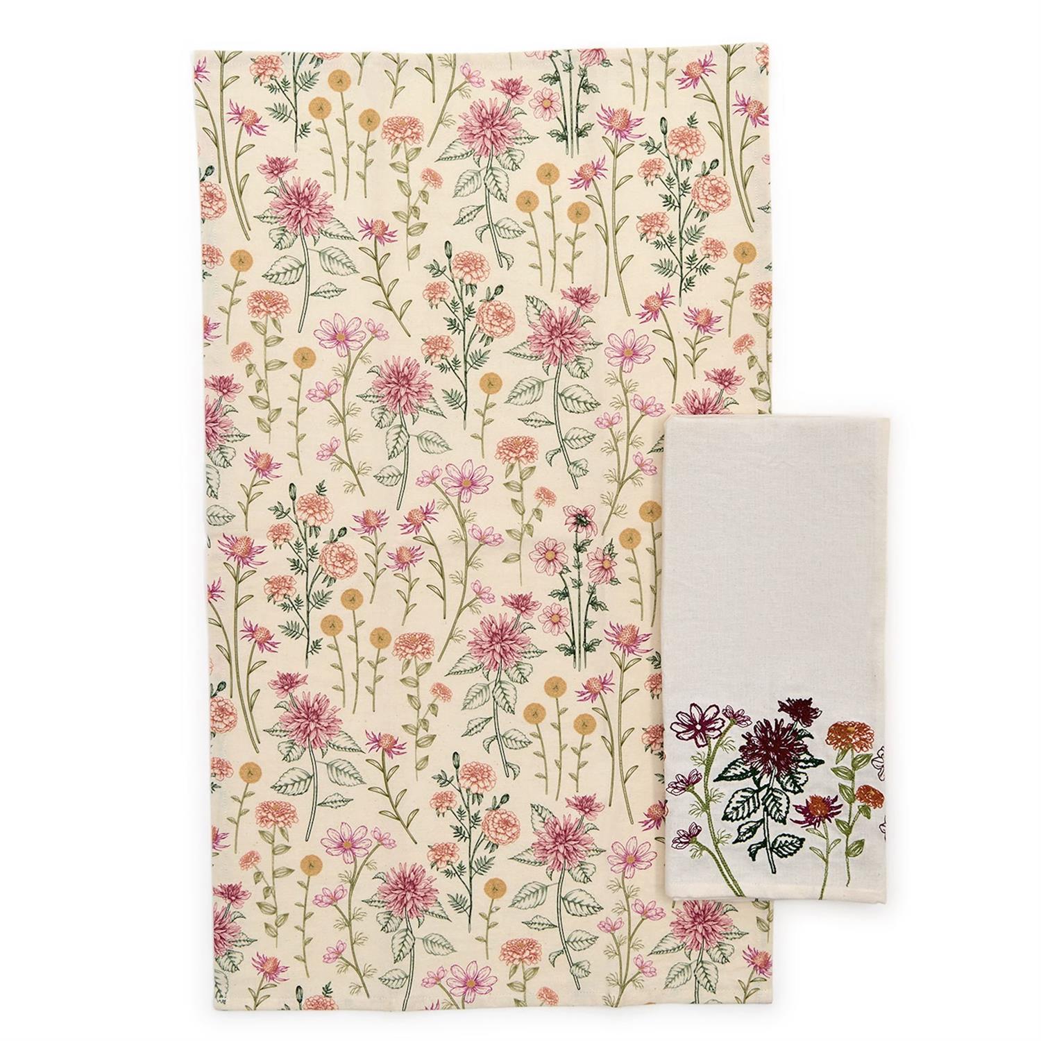 Floral patterned towel set with a plain white towel on a beige background