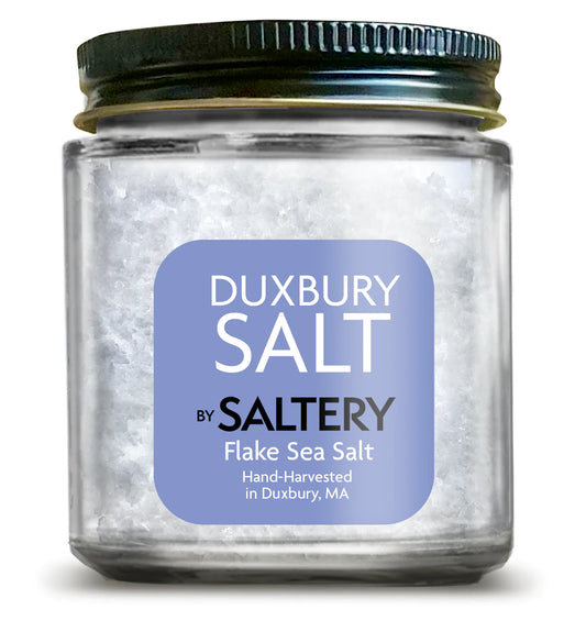 Classic jar of Duxbury Salt with a blue label and a black lid.