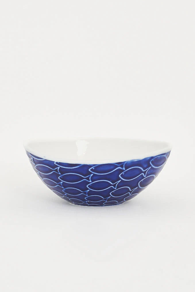 A blue and white ceramic bowl with embossed fish pattern