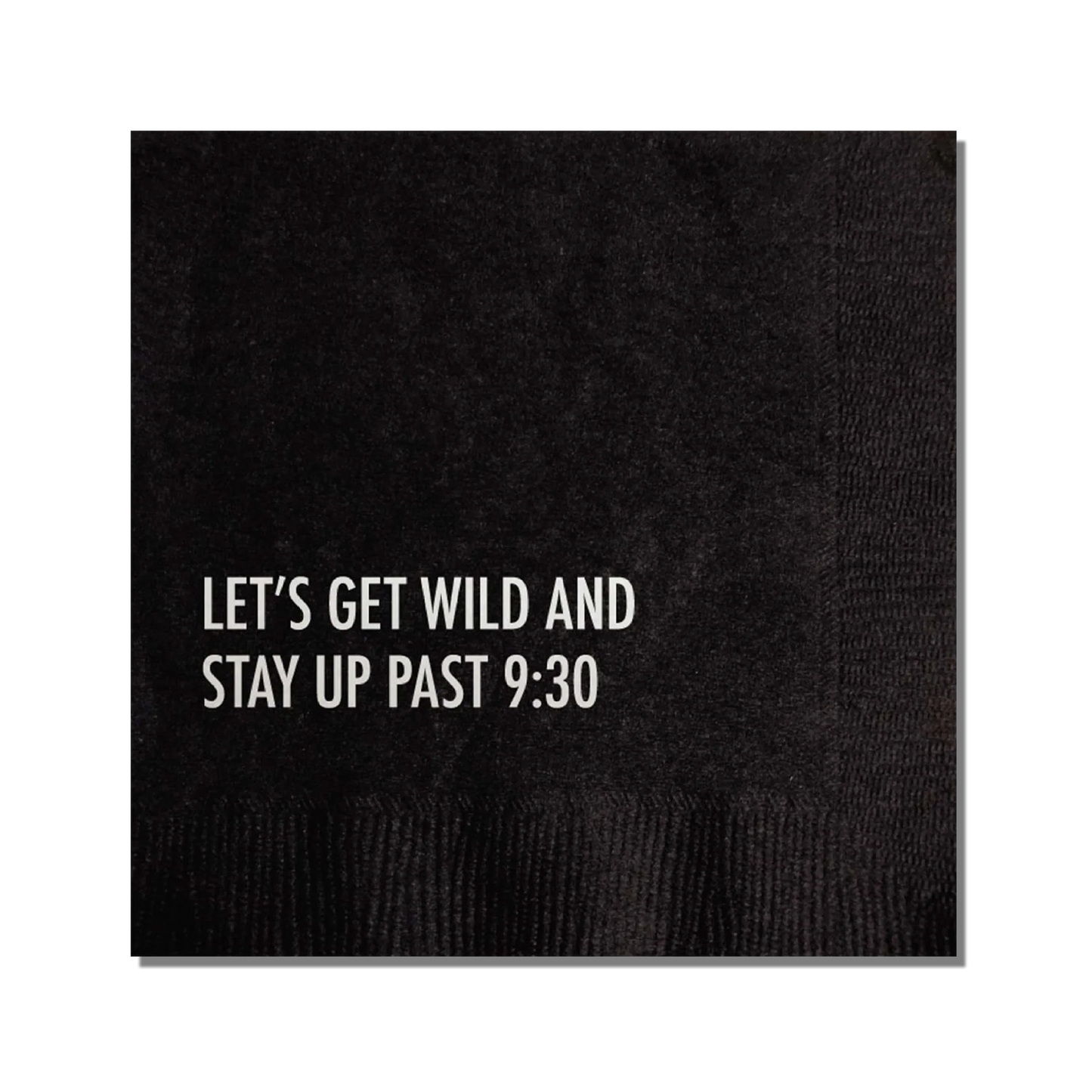 A black cocktail napkin with the text 'LET'S GET WILD AND STAY UP PAST 9:30' printed in silver.