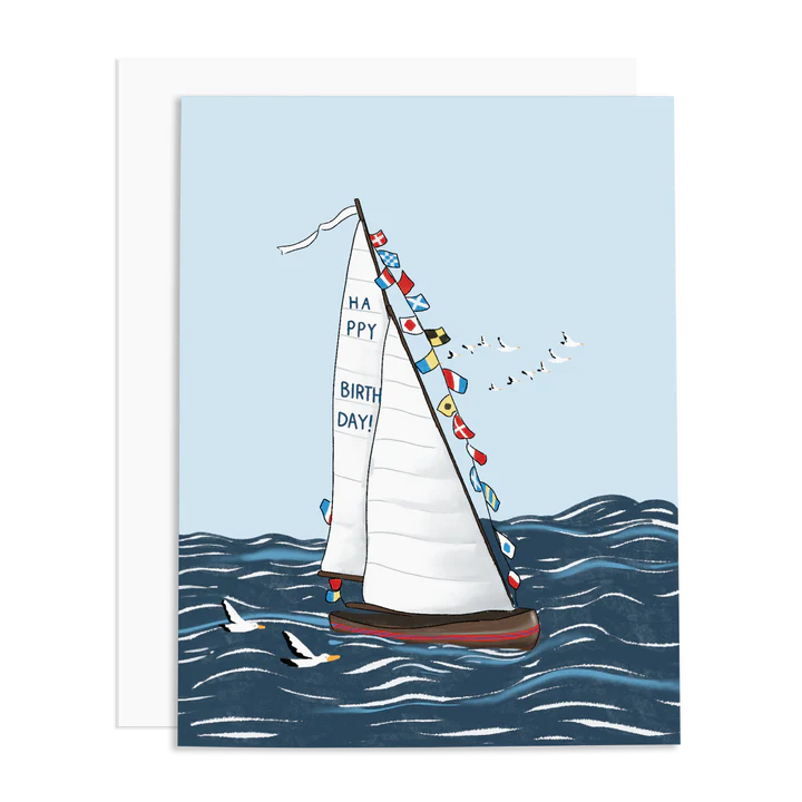 A greeting card featuring a sailboat with a 'Happy Birthday' message and Nautical flag decorations, including sea gulls on a blue background.