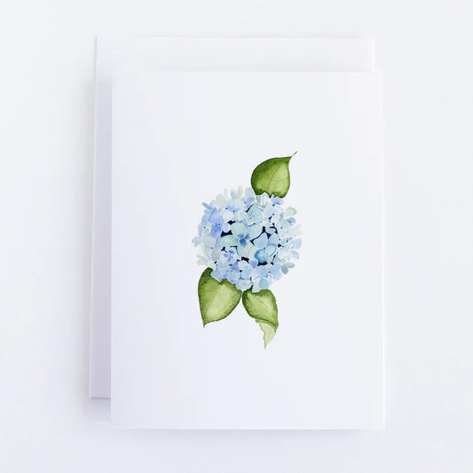 White notecard with a blue hydrangea flower in the center