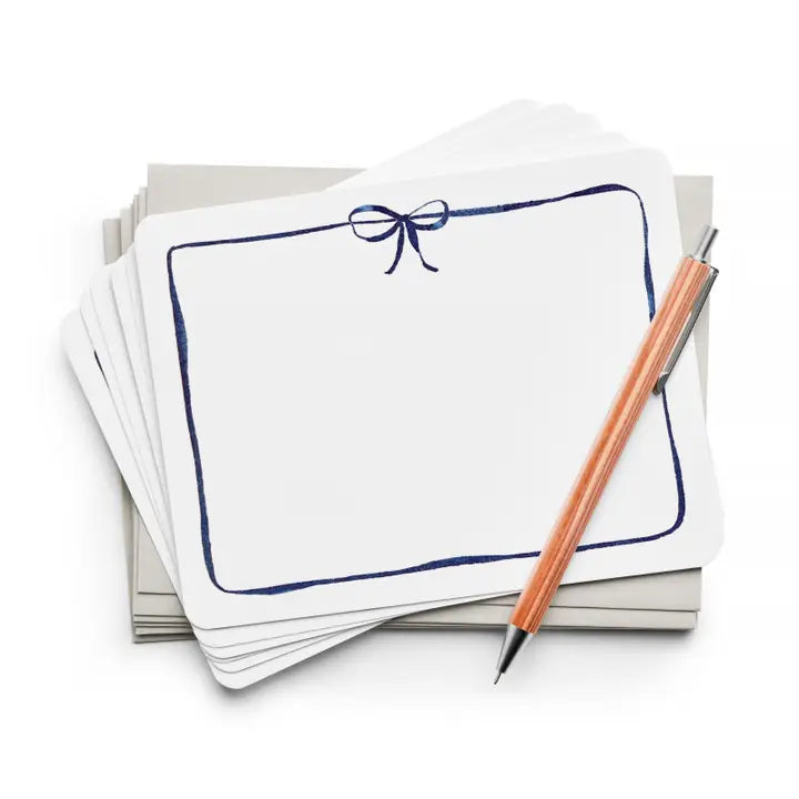 White note card Set with a blue border that has a Navy blue bow on the top middle.