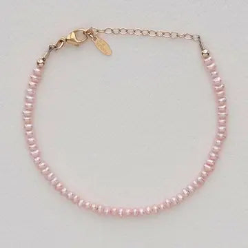 Pink pearl bracelet on a light gray background