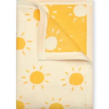 Blanket with yellow sun patterns on a white background