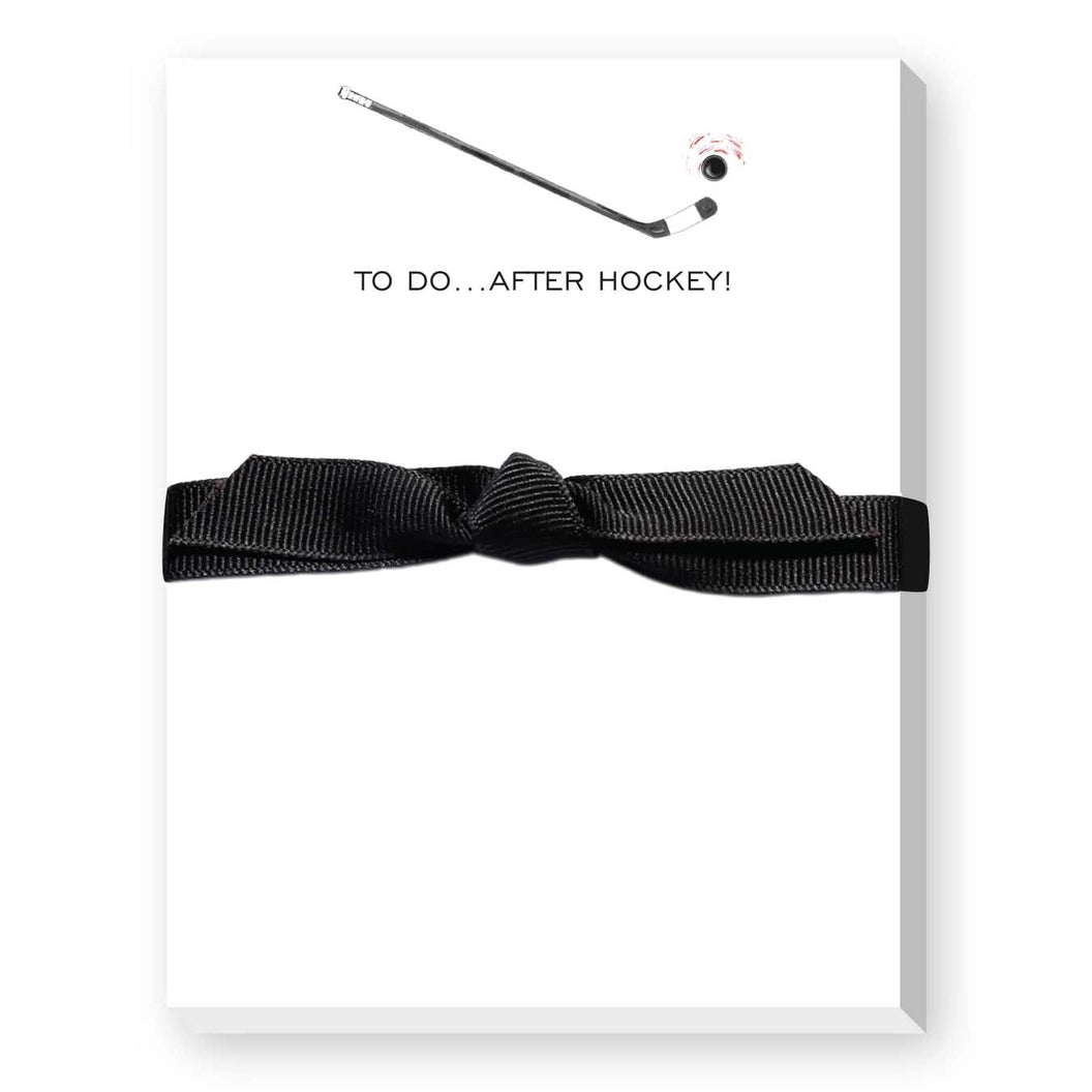 Black ribbon on a white notepad with text 'TO DO...AFTER HOCKEY!' on a white background