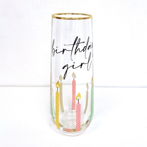stemless champagne glass with gold rim birthday girl in script candles are multi color pastel