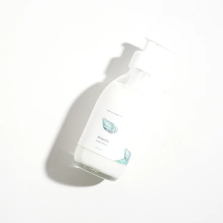 Atlantic cented lotion lying flat in a clear bottle
