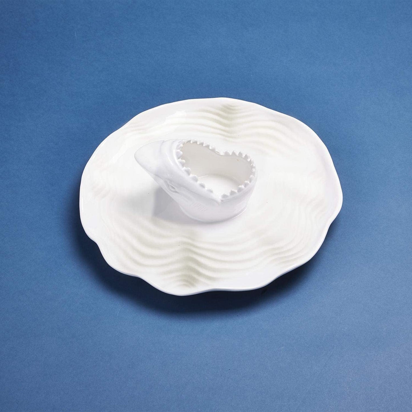 A white ceramic chip and dip bowl with a great white shark design in the center