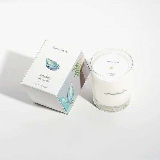 Sented Candle with a white box and gray ocean on it