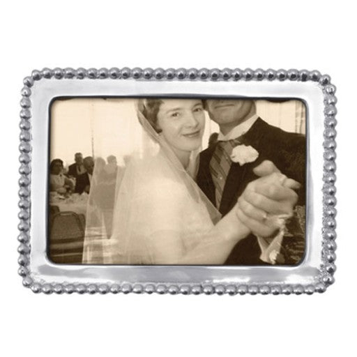 Horizontal frame that is silver and beaded on the edges