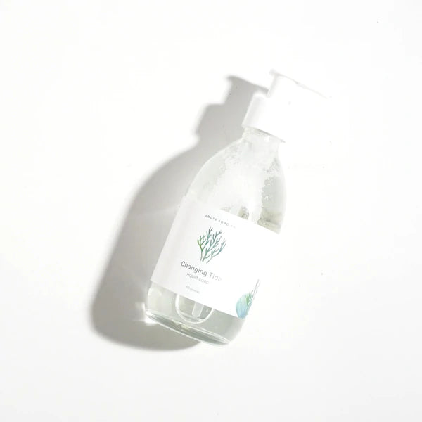 Changing Tide soap in a clear bottle lying flat