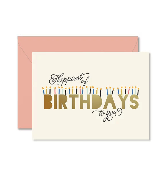 White greeting card with script Happiest of Birthdays to you.  The word BIRTHDAY has candles stacked on top of the letters