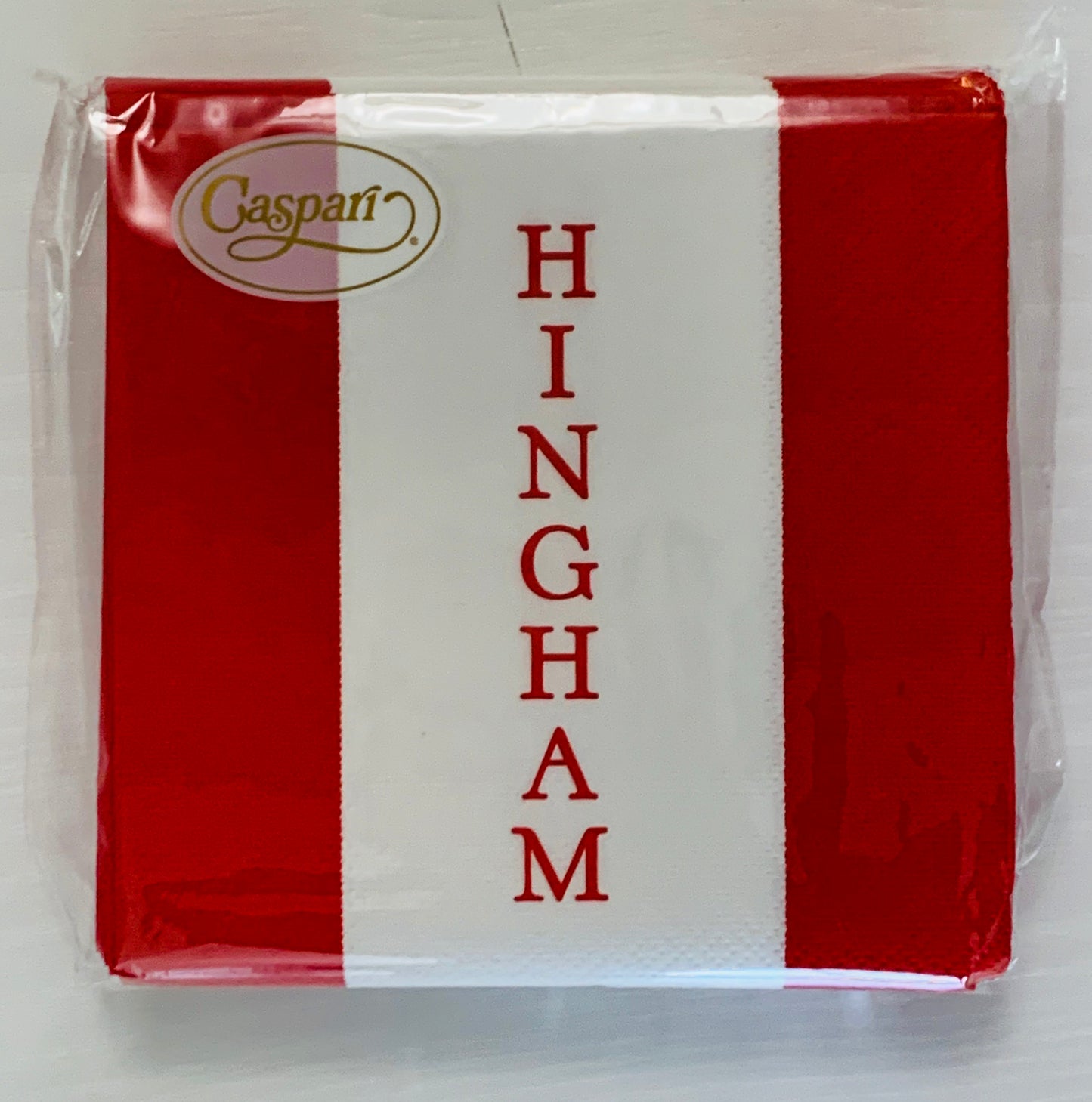 Cocktail Napkin with 3 stripes red white red. on the white center stripe the word HINGHAM is vertical in red