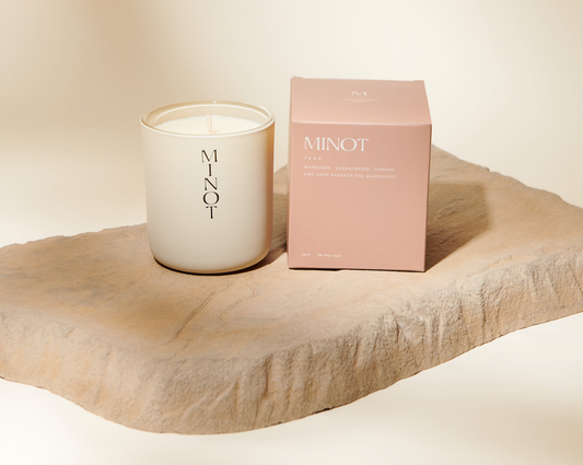 White Minot candle with a light pink box