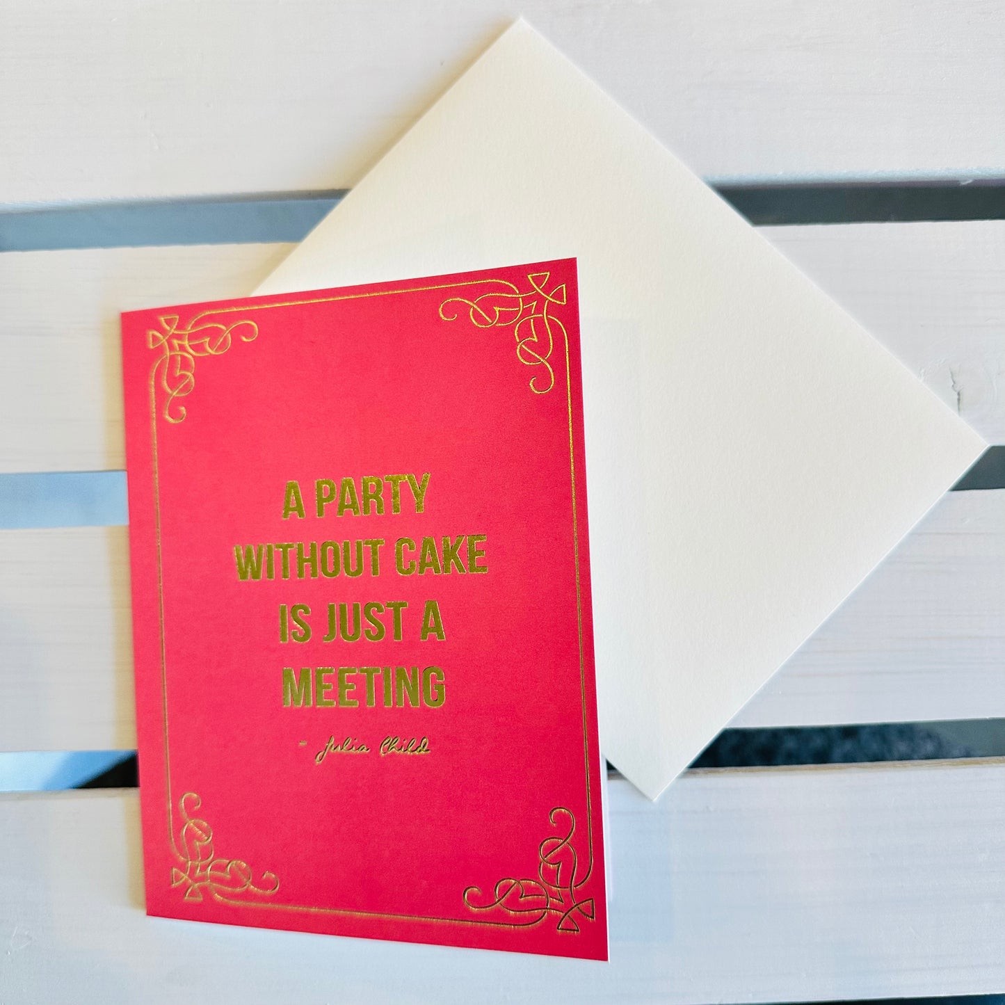 Hot Pink Card. States A Party without cake is just a meeting. In bold font with gold letters