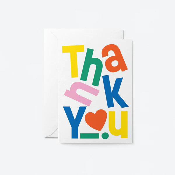 A colorful greeting card with the words 'Thank You' in different colors and a heart symbol, blank inside, placed against a white background.