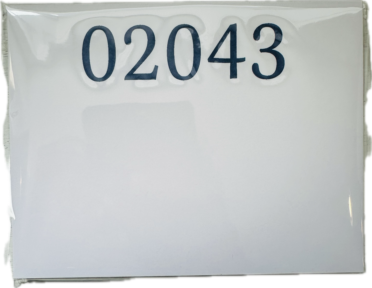 A white notepad with the zip code 02043 printed on the top in navy 
