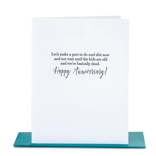 White Anniversary greet card with humorous text in black in with a teal envelope