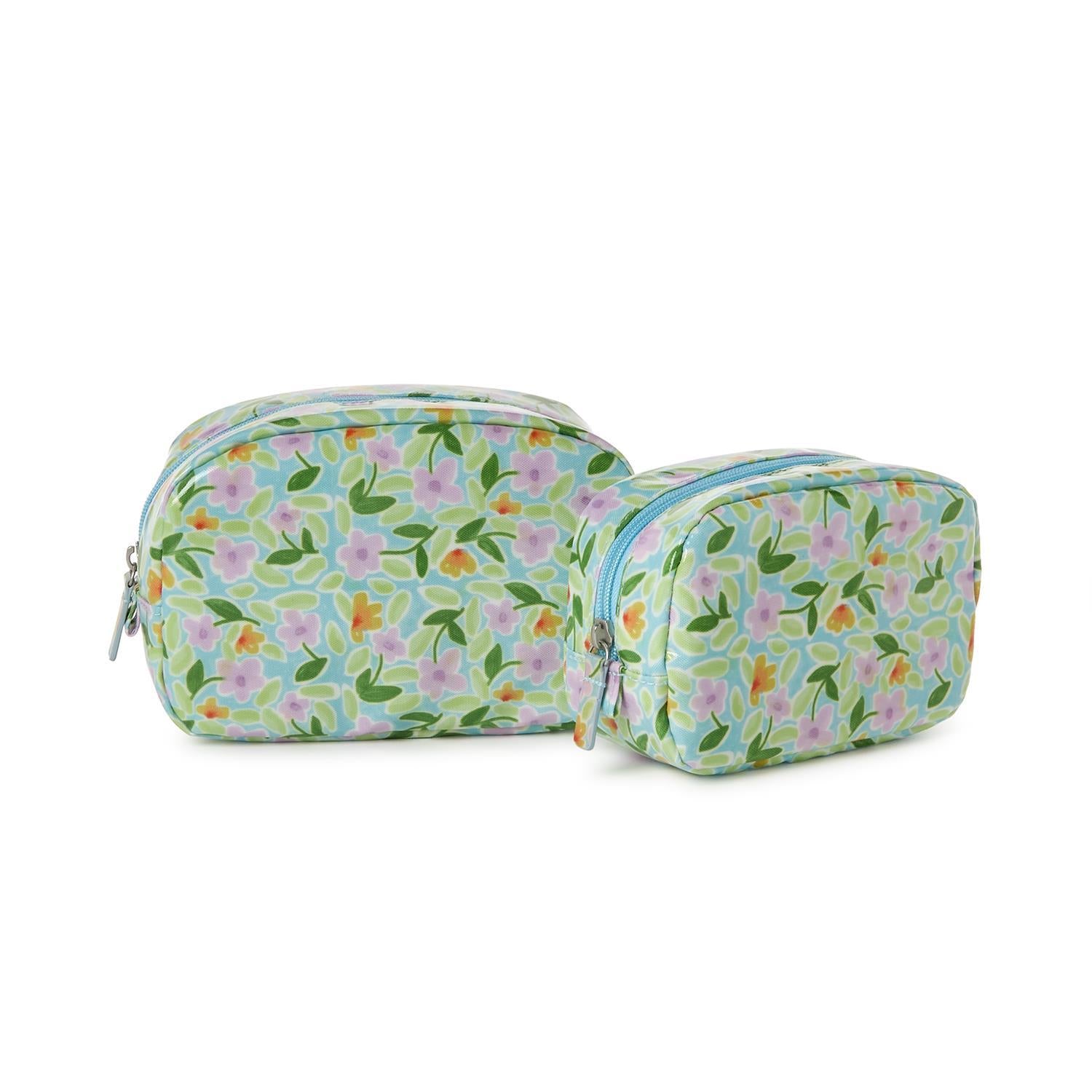 Two blue floral-patterned pouches on a white background