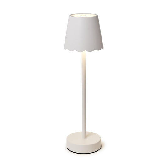 White table lamp with a scalloped shade on a white background