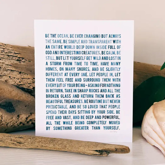 White card wtih blue 'washed' print. Font in block letters.  Be the Ocean Poem