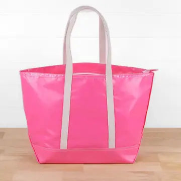 Bright pink-colored, water-resistant tote bag with  canvas-colored, cotton shoulder straps