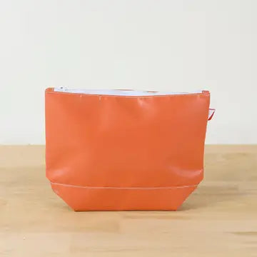 Orange colored, water-resistant pouch with a chunky white zipper