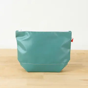 Pine green colored, water-resistant pouch with a chunky white zipper