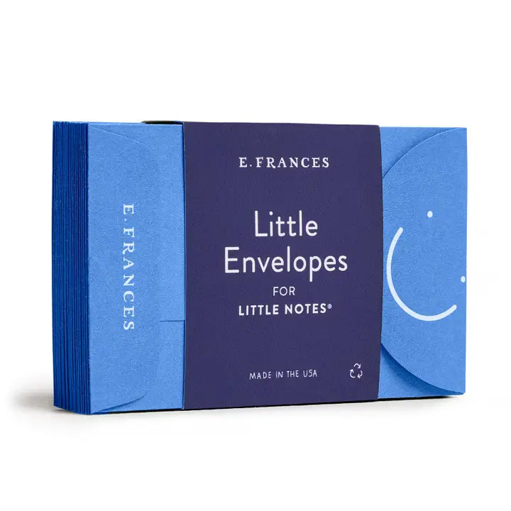 A stack of little blue envelopes with a white smiley face for any of the E. Frances Little Notes notecards