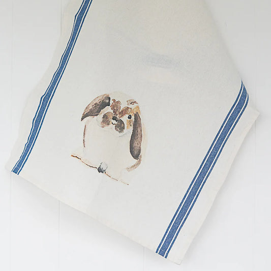 White towel with blue trim featuring a bunny design on a white background