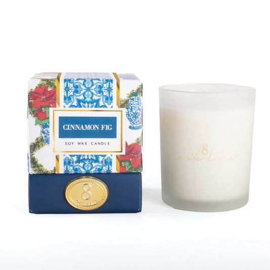 Cinnamon Fig candle with decorative poinsettia and toile packaging on a white background