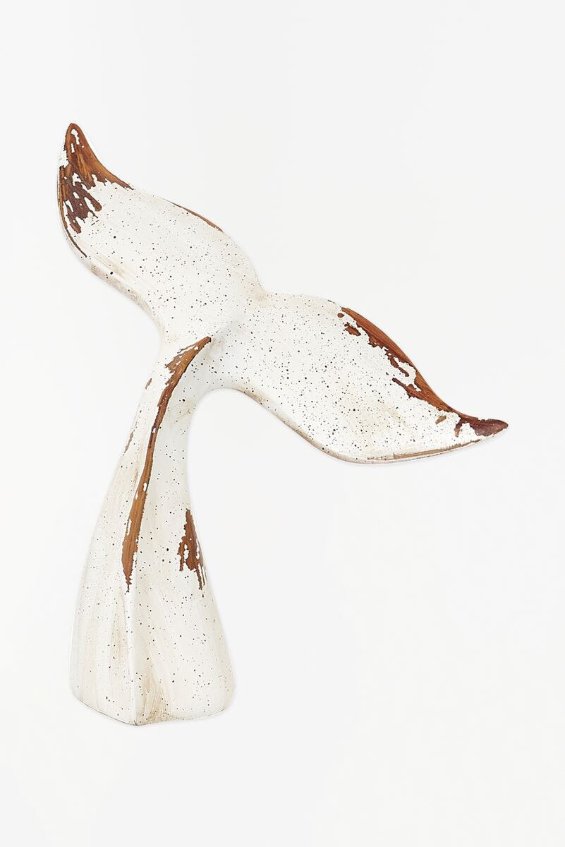Decorative wooden carving of a whale tail on a white background