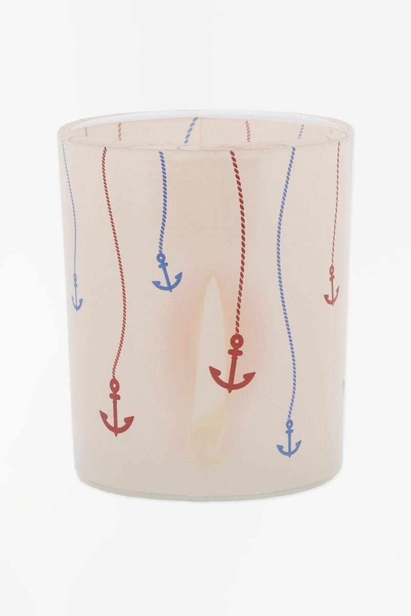 Glass votive candle holder with red and blue anchor and rope designs on a white background
