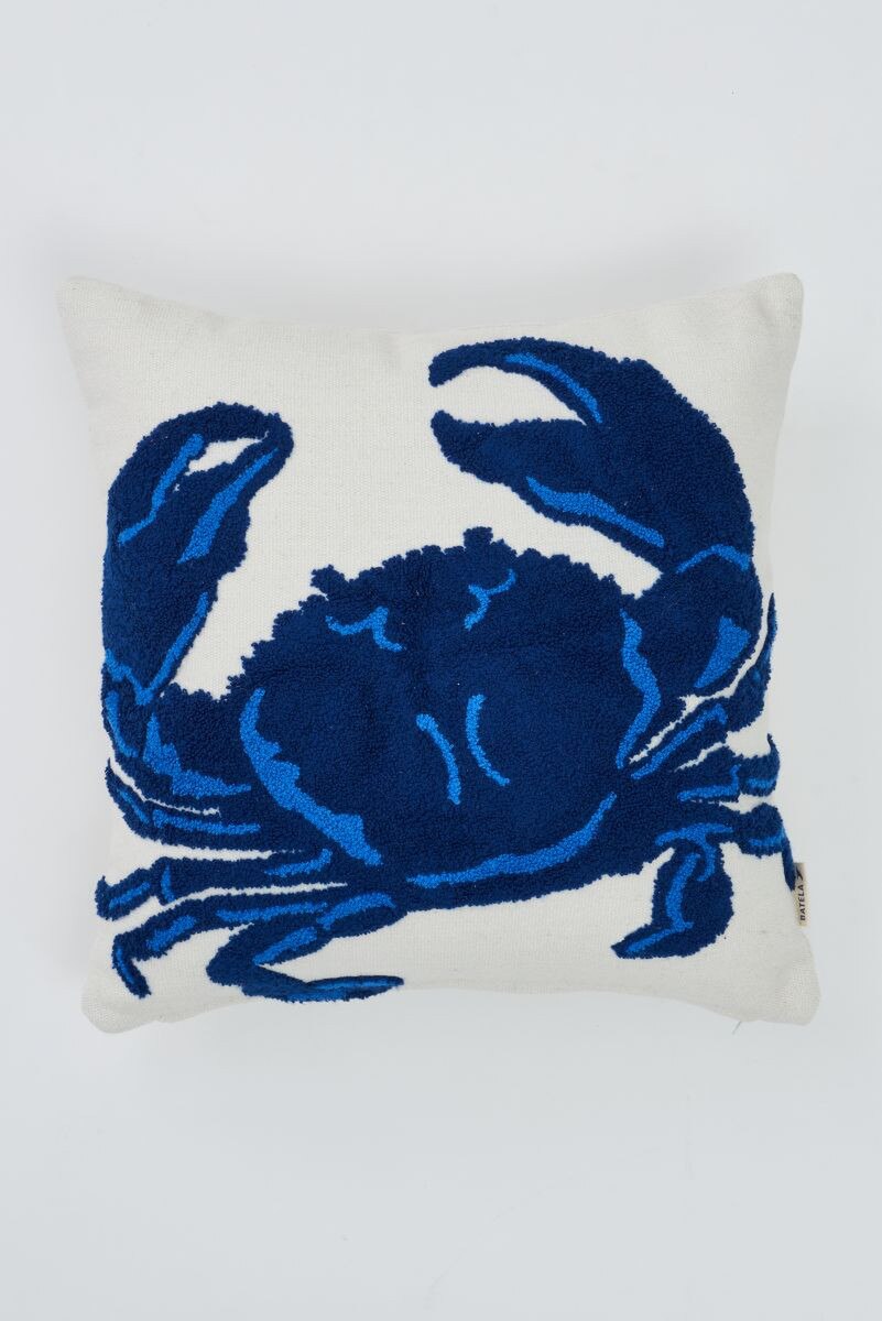 Light cream pillow with an embroidered navy blue crab design 
