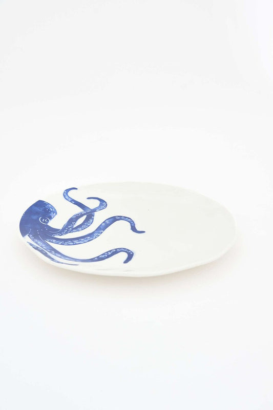 White plate with a blue octopus design 