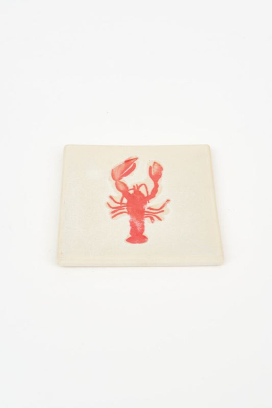 Ceramic coaster with a red lobster design on a white background