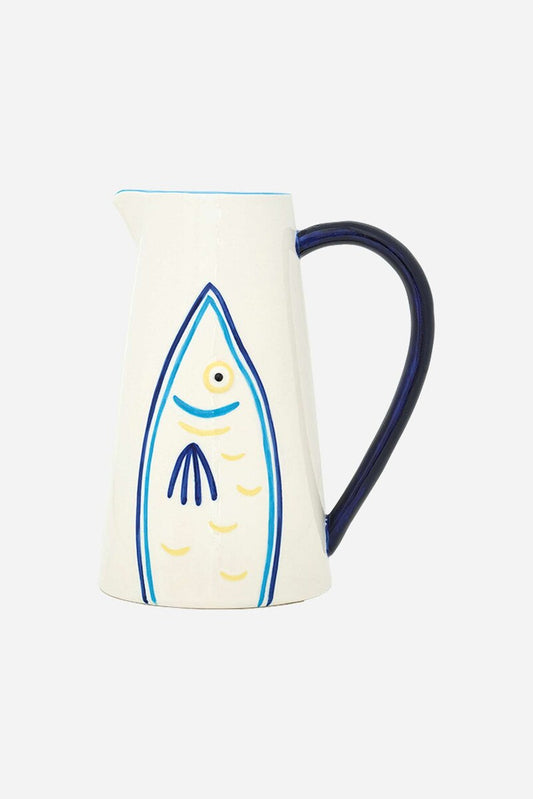 Ceramic pitcher with blue and yellow fish design on a white background and a blue handle
