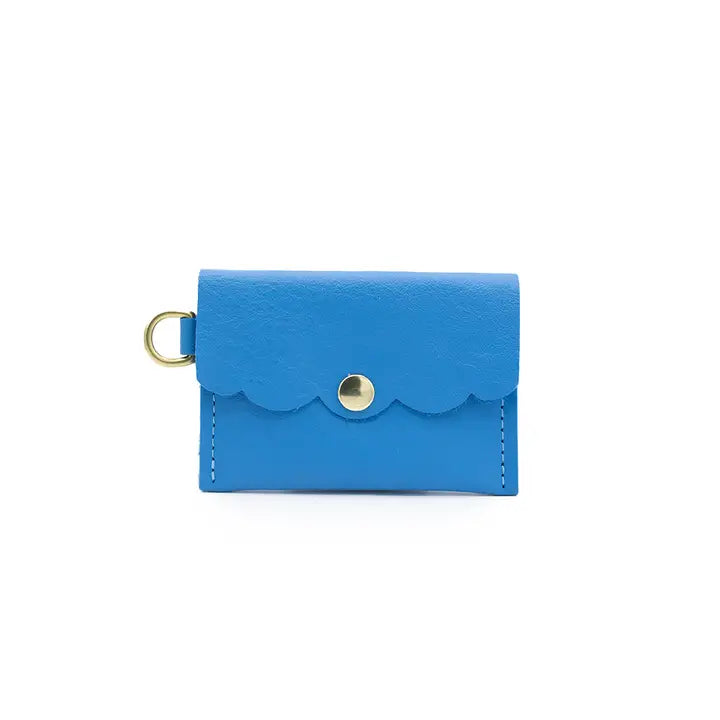 Mini leather wallet in sky blue with decorative scalloped flap, snap closure and side brass ring