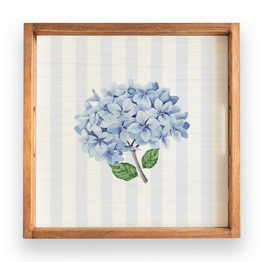 Wooden Tray with light blue stripes as the background and a blue hydrenga in the middle