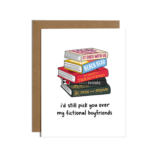 Stack of romance books with 'I'd still pick you over my fictional boyfriends' written below on a greeting card with a brown envelope.