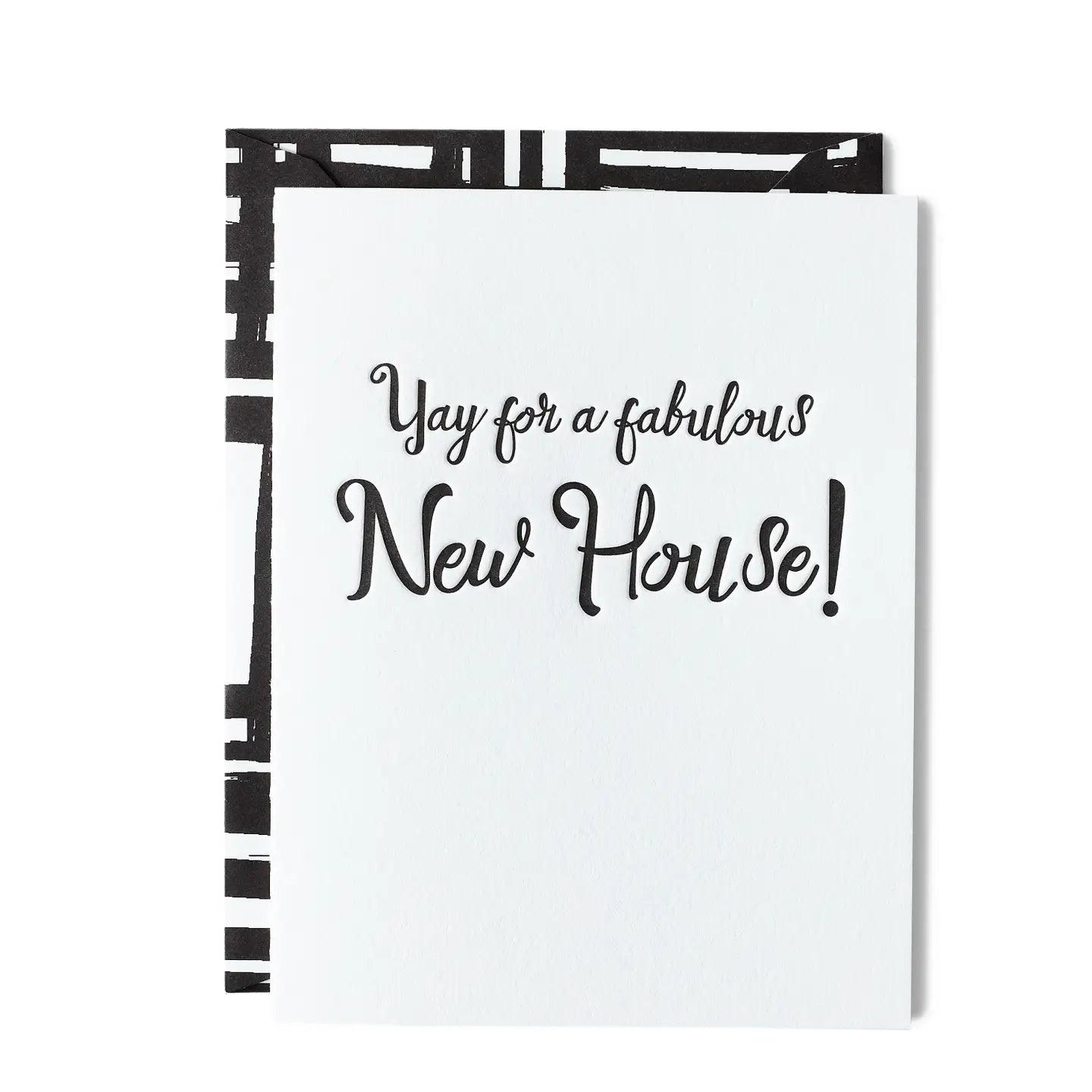 White greeting card with 'Yay for a fabulous New House!' in black text with a black & white geometric pattern envelope