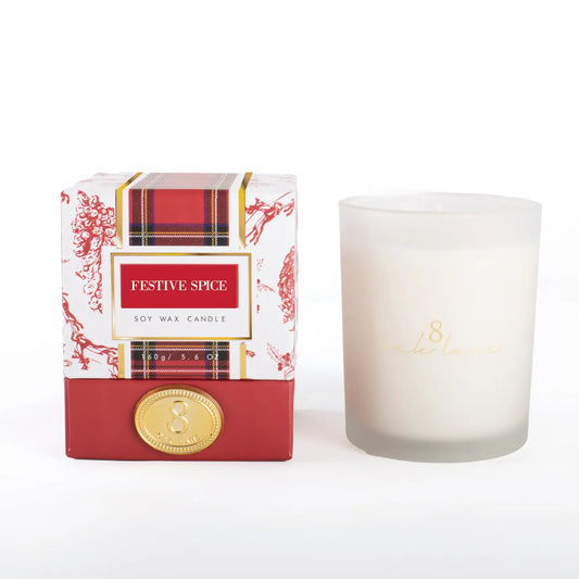 Festive spice candle with berry and tartan packaging on a white background
