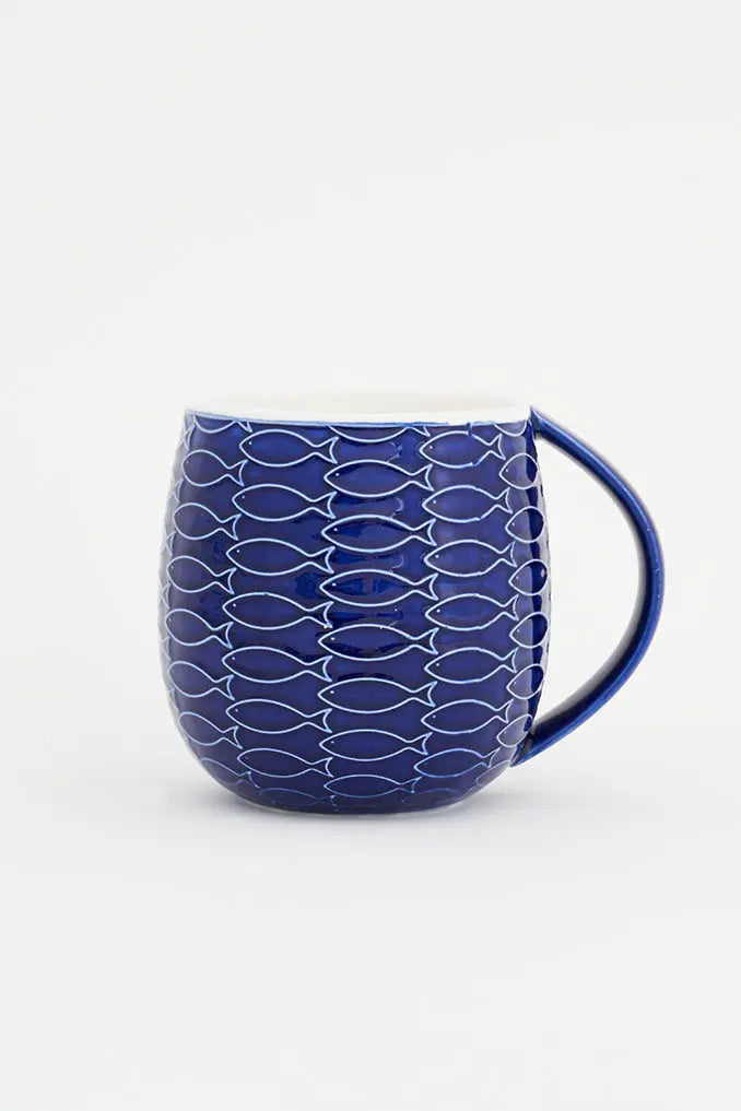 A large ceramic coffee mug with a blue and white fish pattern and a handle on the side