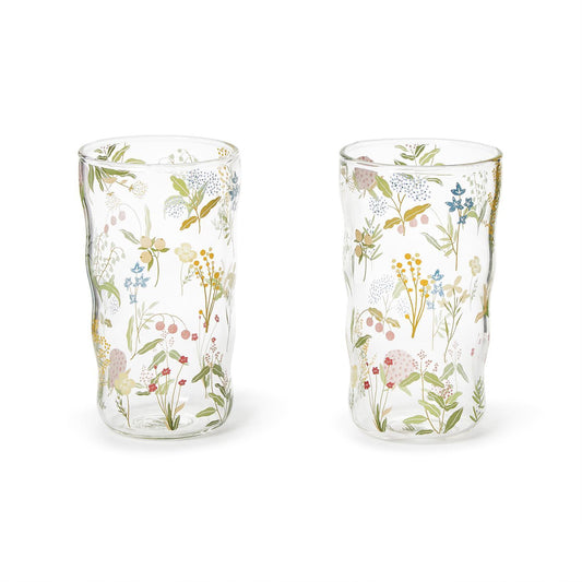 Two clear glass tumblers with floral patterns on a white background