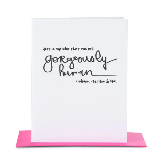 White greeting card with motivational message written in black with hot pink envelope 